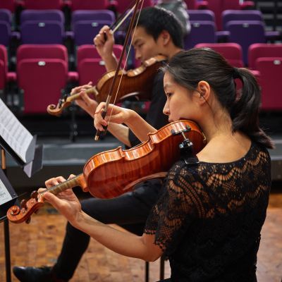 Violinists performing as part of a chamber group